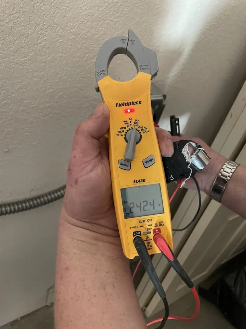 Voltage testing with clamp meter during Recessed Lighting Installation in Lower